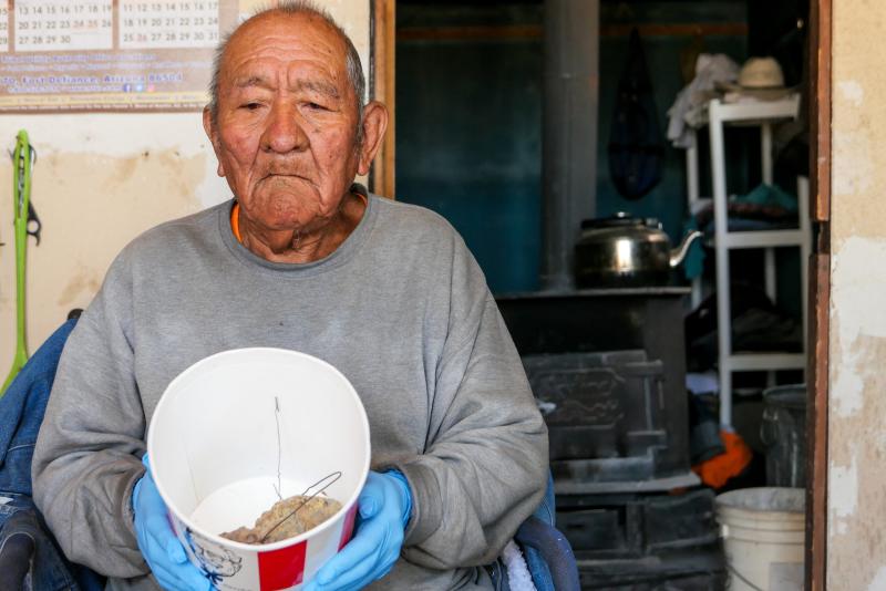 Bob Begay, 85, a former uranium miner who suffers from idiopathic pulmonary fibrosis, displays two keepsake chunks of radioactive ore in his home on the Navajo reservation in Rough Rock, Arizona. Photo: Eli Cahan.