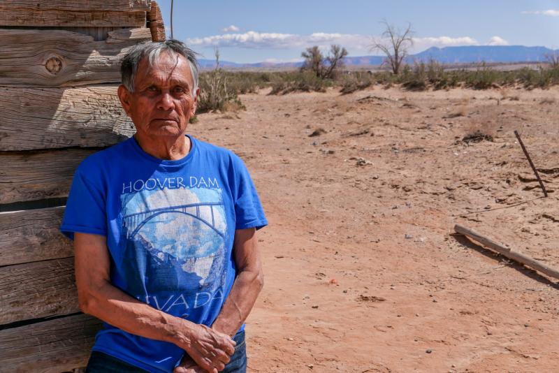 Edison Bia, 76, a former uranium mine reclamation worker, stands outside his home on the Navajo reservation in Many Farms, Arizona. Photo: Eli Cahan.