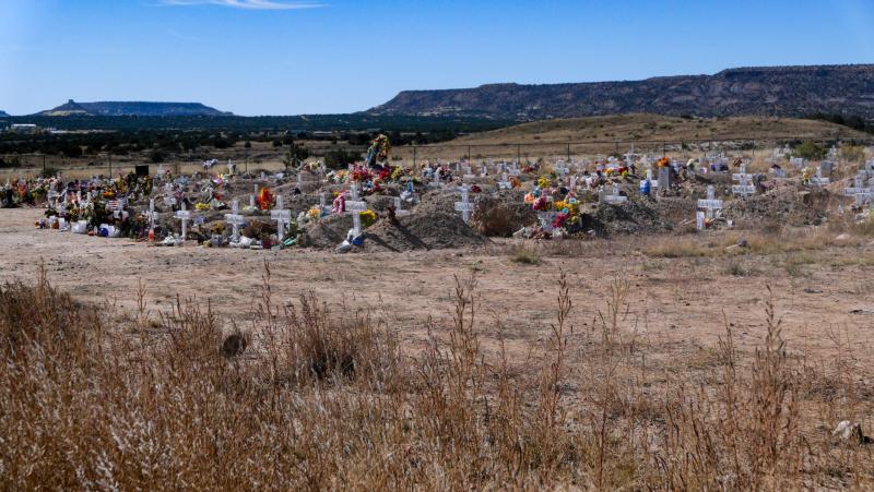 Fresh flowers mark the graves of recently buried members of the tribe, many of whom succumbed to COVID-19, at the Laguna Pueblo cemetery. The tribe expanded the cemetery in response to the COVID-19 death toll. Photo: Eli Cahan.