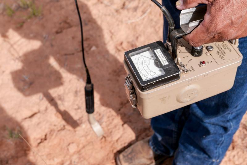 Radiation levels register over 2 millirems per hour on a Geiger counter at a uranium tailings pile located in Henry and Perry Tso’s childhood backyard on the Navajo reservation in Tse Tah, Arizona. The EPA says that’s over 100 times the expected background radiation level for the region. Photo: Eli Cahan.