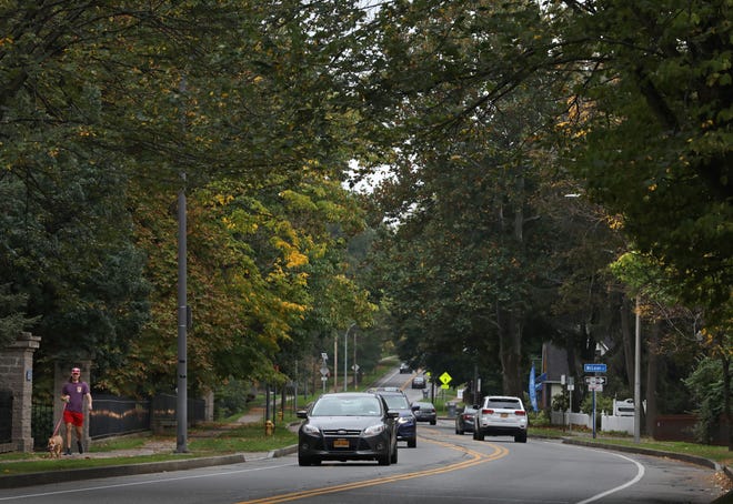 All kinds of traffic, both pedestrian and vehicular, move along under the lush tree canopy along Mt. Hope Avenue in Rochester Friday, Oct. 15, 2021. Shawn Dowd, Democrat And Chronicle