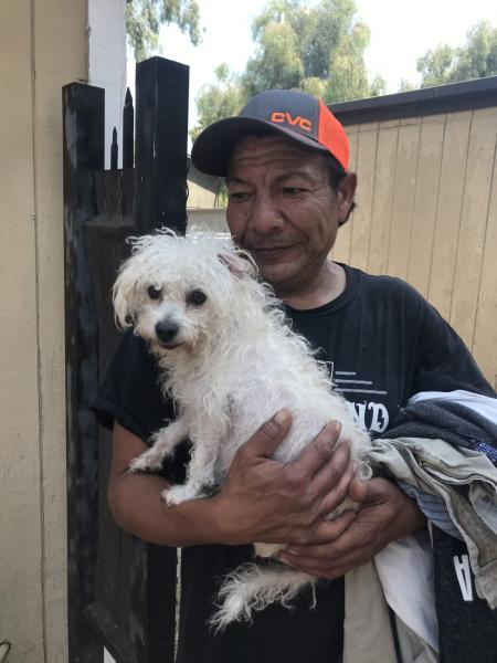Guillermo Hernandez, pictured here with one of his two dogs, was told by his doctor that he needs to stay out of the heat because of the medication he takes. However, the high cost of AC and thin apartment walls makes it difficult to stay cool indoors.