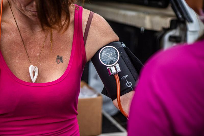 Anna Cummings checks Melissa’s vitals as they provide her street medicine in a parking lot in northwest Redding on Sept. 19, 2022. Melissa reached out to Health Outreach for People Everywhere (HOPE) for treatment for her syphilis.