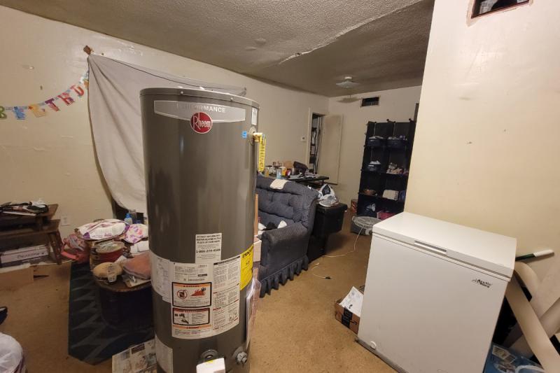 This unit at Sunset Village, observed the night of Oct. 15, 2022, was still having its utilities reinstalled, with its occupant staying at a motel nearby. A concerning crack in the ceiling lingered in the living room. Photo by Nick Judin