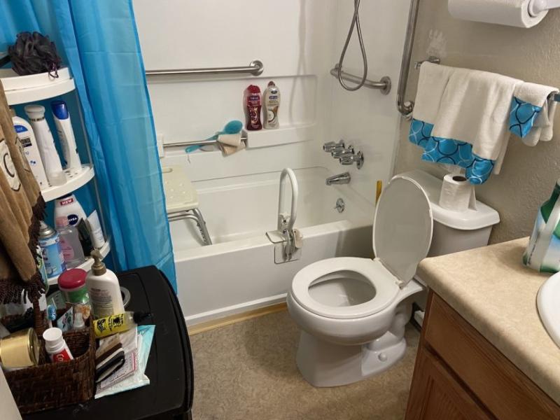 Carolyn's bathroom. She has requested a taller toilet seat for three years because she falls when she uses it alone.