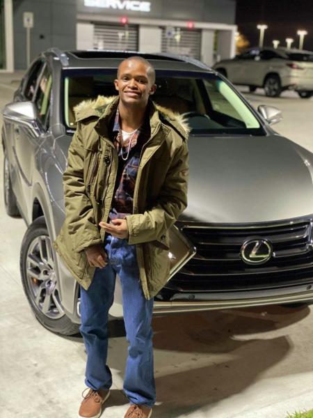 Fred Harris, who had an IQ of 62, stands in front of a Lexus SUV. Fred, who was 19 and had special needs, was killed in an incident with an inmate in the Harris County Jail in 2021.  Courtesy/Fred Harris family