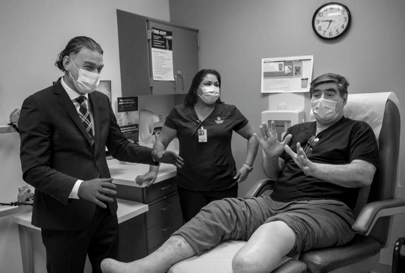 Dr. Thomas Zgonis, a podiatric surgeon, checks in on patient Salvador Martinez at the Texas Diabetes Institute in San Antonio. Martinez said even though Type 2 diabetes runs in his family, he didn't realize he was sick until he fell on a sidewalk.  Josie Norris / San Antonio Express-News