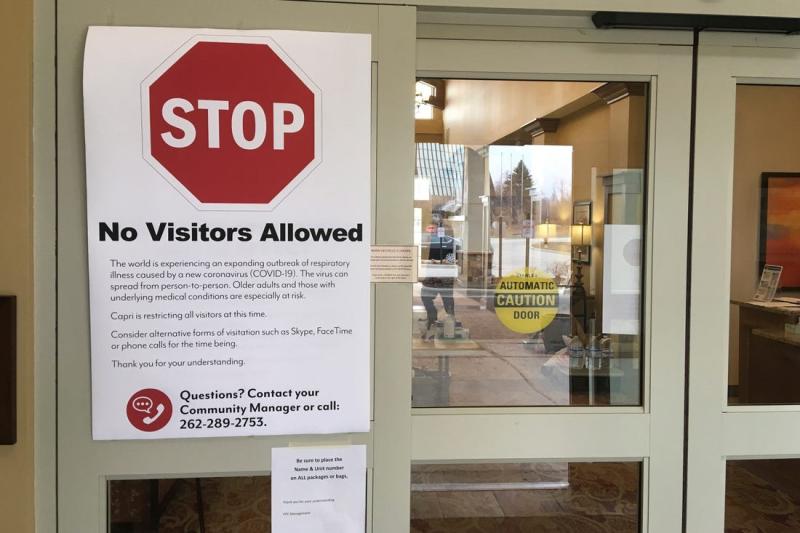 Protocols called for nursing homes to limit and ultimately ban visitors for a period of time during the pandemic. Here a March 27, 2020 photo shows a no visitors allowed sign at Village Pointe Commons, a senior care facility in Grafton, Wisconsin. GRETCHEN EHLKE, AP; SETH WENIG, AP