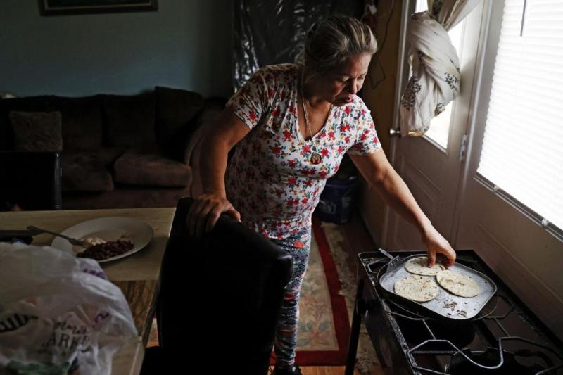 Maria Fuentes warms tortillas on a gas stove in her home at The Communities at Southwood in Richmond, where she had found a "till death do us part" kind of love.  Eva Russo/times-dispatch
