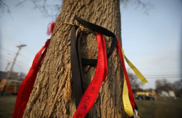 Banners with wishes written on them hang from a box elder tree in an empty lot along Joseph Avenue. SHAWN DOWD, DEMOCRAT AND CHRONICLE