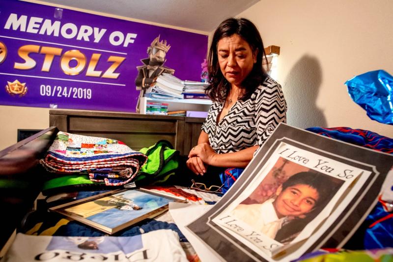 Juana Salcedo, aunt of Diego Stolz, who raised him since he was an infant, holds back tears as she looks at the mementos and photographs belonging to Diego at their Moreno Valley home Sept. 14, 2020. Diego Stolz, 13, died after being assaulted by two fellow students at Landmark Middle School in September 2019. (File photo by Watchara Phomicinda, The Press-Enterprise/SCNG)