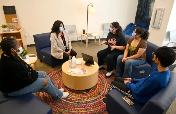 Lawndale High School students chat with social worker, Celeste Lopez in the school’s wellness center, in Lawndale on Wednesday, March 16, 2022. Some school districts offering places where students have easy access to counselors and mental health support has shown dramatically lowered bullying rates in self-reported student surveys. (Photo by Brittany Murray, Press-Telegram/SCNG)