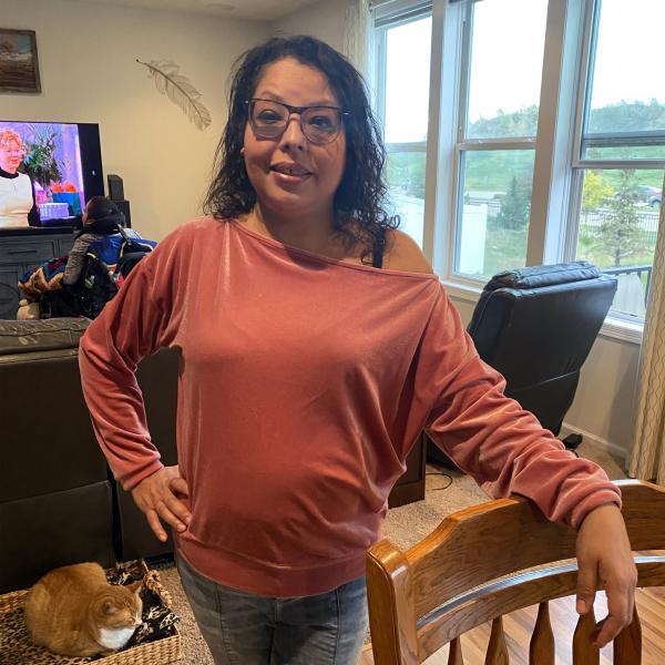 Shana King, pictured here at her home outside of Minneapolis, Minnesota on Oct. 10, 2021, is a Native mother who had her children removed. She is a member of the MHA Nation. Her son Jo Shawn, is in the background. (Jessica Washington/The Fuller Project)