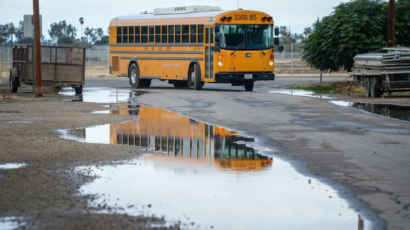 A West Park School District school bus turns onto South Prospect Avenue from West Church Avenue south west of Fresno on Monday, Oct. 25, 2021. Rural roads in Fresno County are neglected due to a county decision to not maintain them. That means potholes, flooding and basic safety measures go unfixed. CRAIG KOHLRUSS CKOHLRUSS@FRESNOBEE.COM