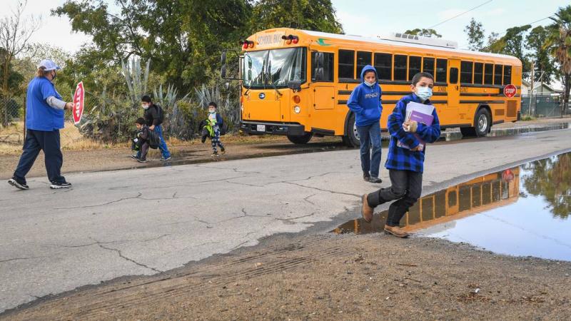 Kids unload from a West Park School District school bus south west of Fresno on Monday, Oct. 25, 2021. Rural roads in Fresno County are neglected due to a county decision to not maintain them. That means potholes, flooding and basic safety measures go unfixed. CRAIG KOHLRUSS CKOHLRUSS@FRESNOBEE.COM