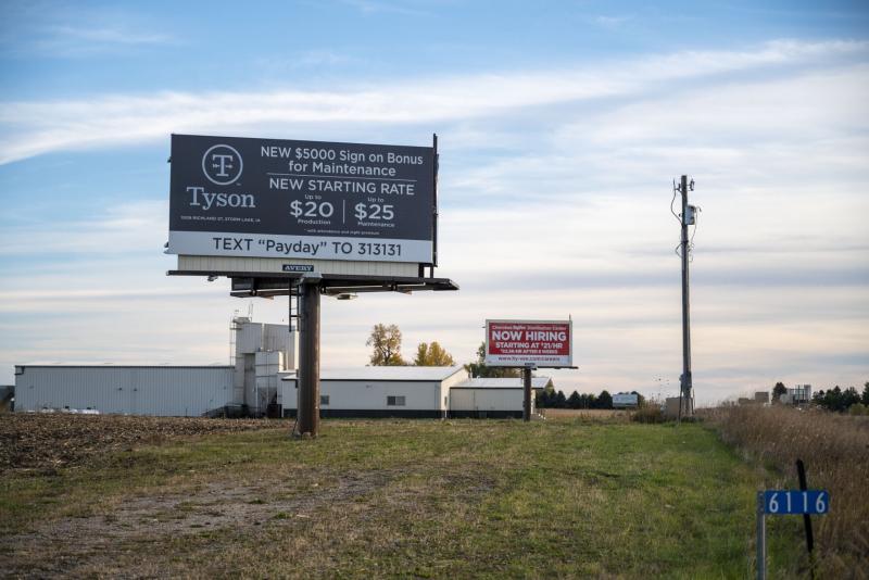 Signs around town advertises higher wages and sign on bonuses to attract more workers as the industry is experiencing a workforce shortage. Natalie Krebs / IPR