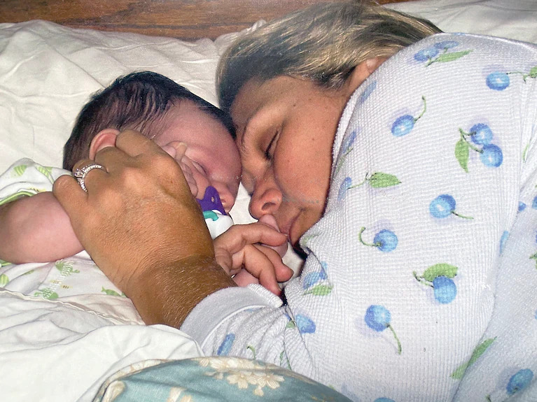 Lisa Rowe holds her son just days after his birth mother delivered him in Florida in 2004. (Family photo)