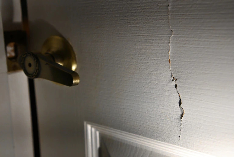 Damage on the bedroom door of Lisa Rowe's son. The door was kicked in by police, responding to a crisis call at the home. (Matt McClain/The Washington Post)