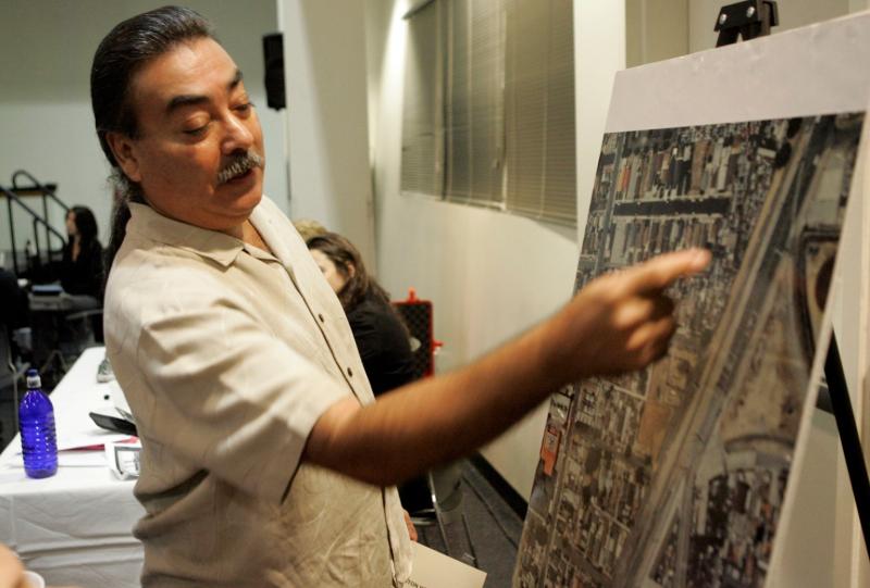 Wilmington resident Jesse Marquez presents his own aerial photo to express his opposition to the construction of a new bridge and truck expressway. Lawrence K. Ho / Los Angeles Times via Getty Images