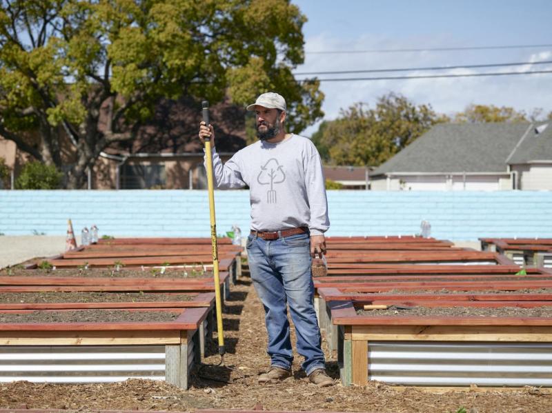 Octavio Ramirez, master gardener and director of community gardens at Strength Based Community Change stands near raised beds at the Heart of the Harbor Community Garden. Damon Casarez / The Guardian