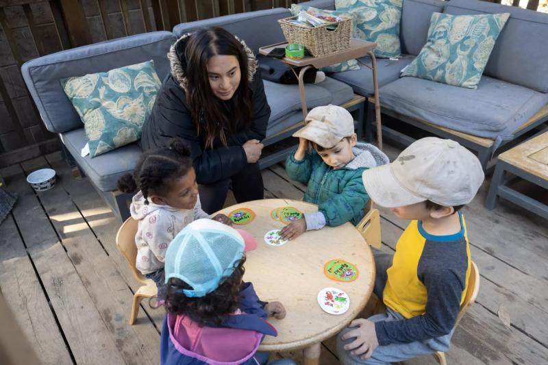 Teacher Sophia Lam (center) supervises an animal card game with children at Baby Steps on Friday, Nov. 18, 2022, in San Francisco.(Paul Kuroda / For The San Diego Union-Tribune)